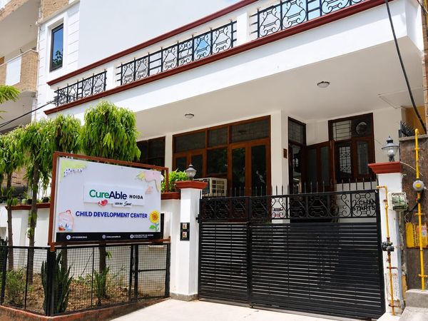 The entrance of CureAble Noida, with the Child Development Center sign at the gate.