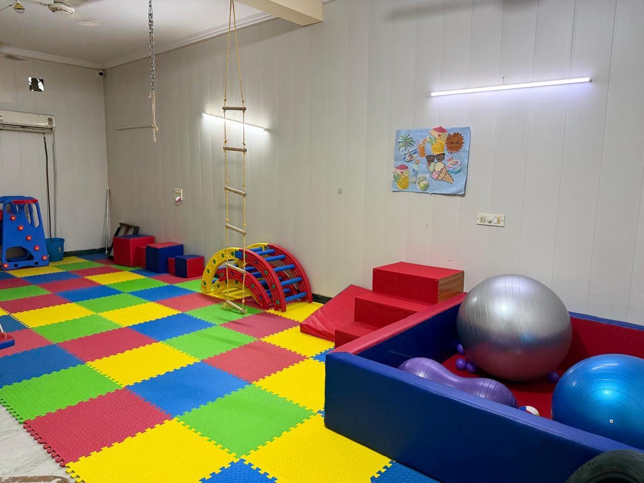 The sensory therapy room at the Noida Centre, with a ball pit, therapy balls, foam steps and a rope ladder.